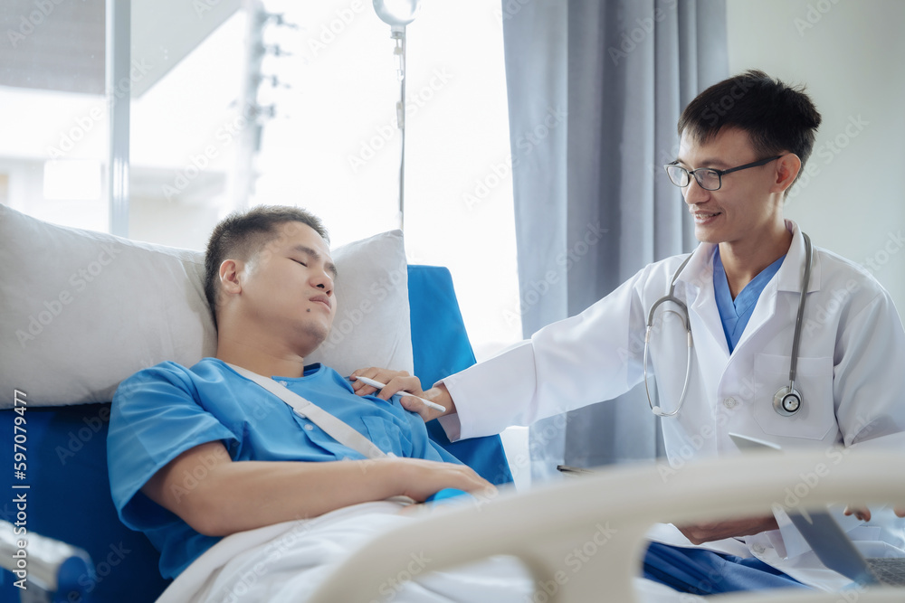 Accident, health and people concept. Doctor talking to male patient on hospital bed. Accident, health and people concept. Doctor talking to male patient on hospital bed.
