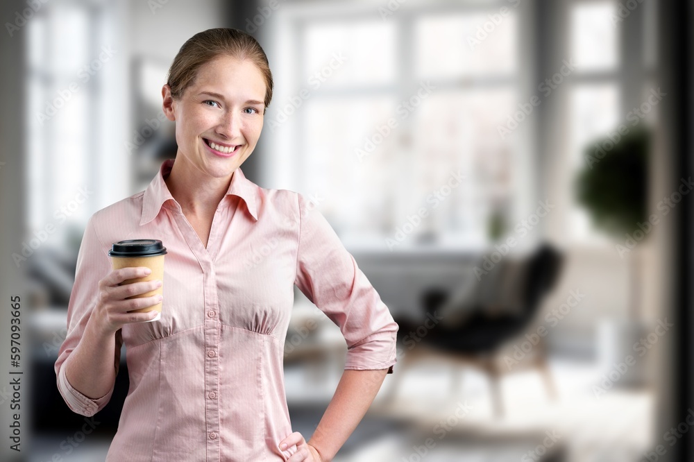 Fototapeta premium Beautiful young woman drink coffee on her kitchen