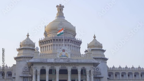 Iconic Karnataka government building Vidhana Soudha with National emblem and Flag waving at the top, Bangalore, India photo