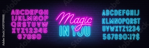 Magic in You neon quote on brick wall background.