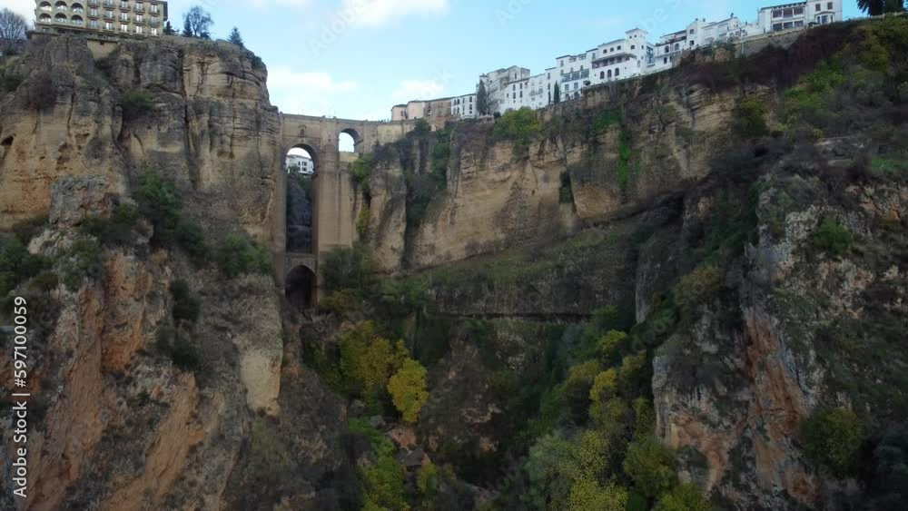 Famous Ronda city bridge and buildings on top of cliff, aerial drone view Famous Ronda city bridge and buildings on top of cliff, aerial drone view