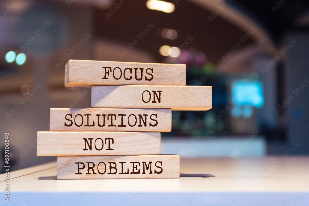 Wooden blocks with words 'Focus on solutions, not problems'. Inspirational motivational quote