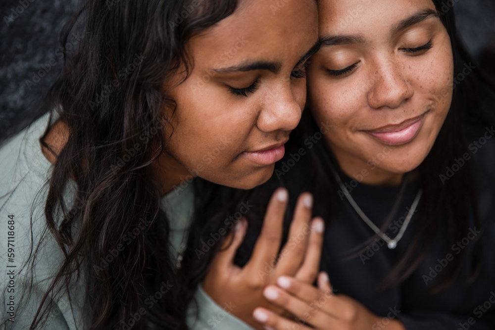Close-up of two Aboriginal girls hugging Close-up of two Aboriginal girls hugging