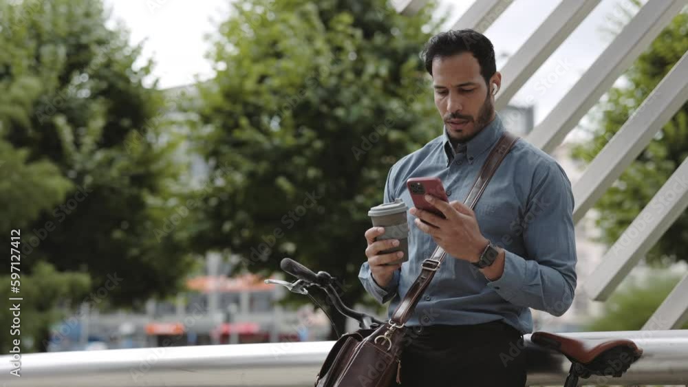 African American Businessman Using Mobile and Drinking Coffee Outside African American Businessman Using Mobile and Drinking Coffee Outside