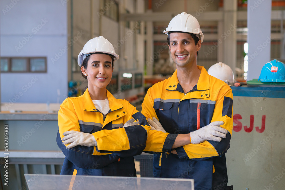 Professional heavy industry engineer worker wearing safety uniform in a metal manufacture warehouse , maintenance service check for safety first concept . Professional heavy industry engineer worker wearing safety uniform in a metal manufacture warehouse , maintenance service check for safety first concept .