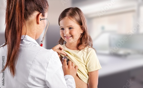 Woman doctor examing little girl