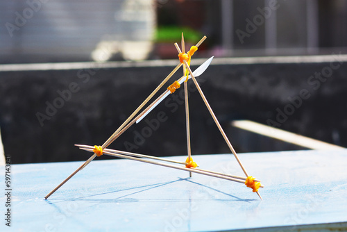 Obraz na plátně Handmade catapult from wooden sticks, elastics and a spoon.