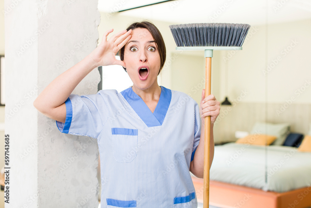 young pretty woman looking happy, astonished and surprised. housekeeper concept young pretty woman looking happy, astonished and surprised. housekeeper concept