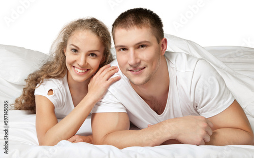 Young couple in bed isolated on white background