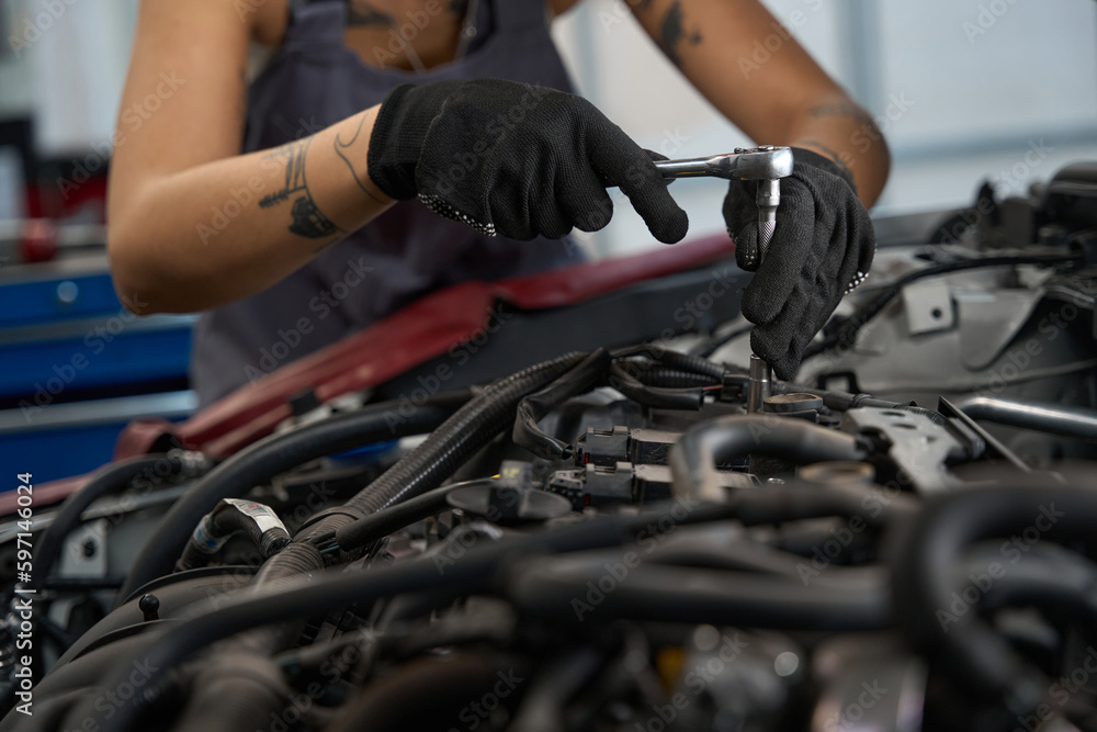 Master at the service station repairs the car engine Master at the service station repairs the car engine