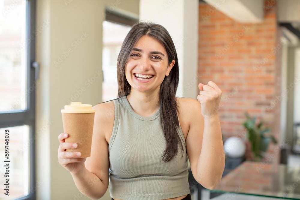 young woman feeling shocked,laughing and celebrating success. take away coffee young woman feeling shocked,laughing and celebrating success. take away coffee