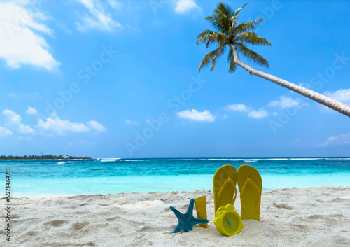 Fototapeta Naklejka Na Ścianę i Meble -  Yellow Flip flop in  tropical summer a holiday and accessories on the beach background