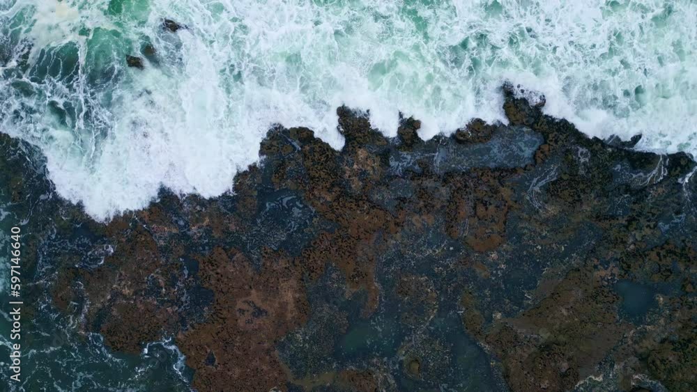 Drone view stormy ocean surf crashing volcanic seaside. Foamy sea waves coast Drone view stormy ocean surf crashing volcanic seaside. Foamy sea waves coast