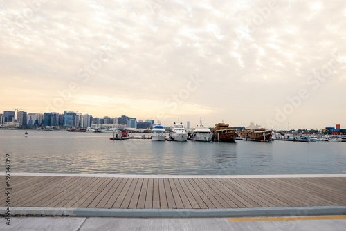 Doha, Qatar - April 25, 2023: Traditional boats called Dhows are anchored in the old Doha port