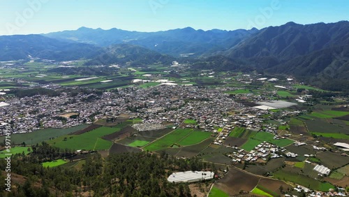 Aerial view of the Constanza town in a valley surrounded by mountains. Agriculture of Dominican Republic, high production of vegetables and fruits photo