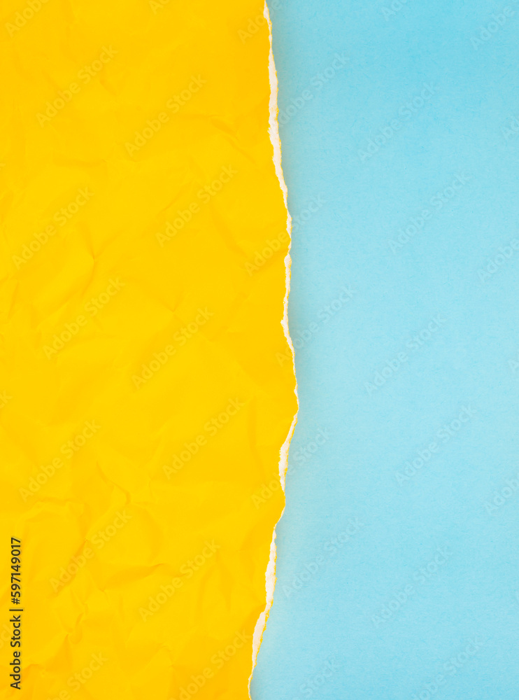 The Vertical torn yellow paper over blue background.