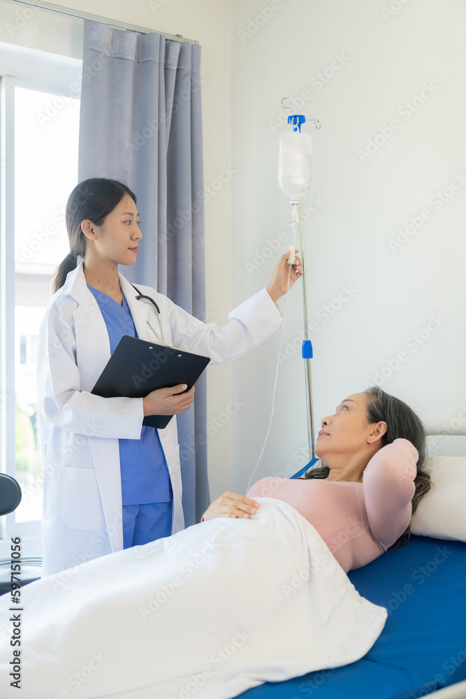 Asian elderly woman smiling happily talking and being comforted by a female doctor who speaks to an elderly woman at a desk explaining the results of the examination, examination, treatment Asian elderly woman smiling happily talking and being comforted by a female doctor who speaks to an elderly woman at a desk explaining the results of the examination, examination, treatment