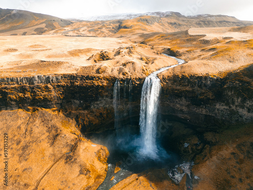View from flying drone. Captivating spring view of Seljalandsfoss waterfall. Colorful sunrise in Iceland, Europe. Beauty of nature concept background.