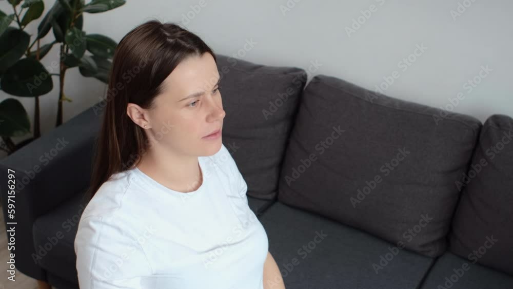 Close up of young pregnant woman doing smooth yoga stretching exercises in living room at home. Relaxed calm future mother practicing yoga exercises. Pregnancy, lifestyle, health and fitness concept Close up of young pregnant woman doing smooth yoga stretching exercises in living room at home. Relaxed calm future mother practicing yoga exercises. Pregnancy, lifestyle, health and fitness concept