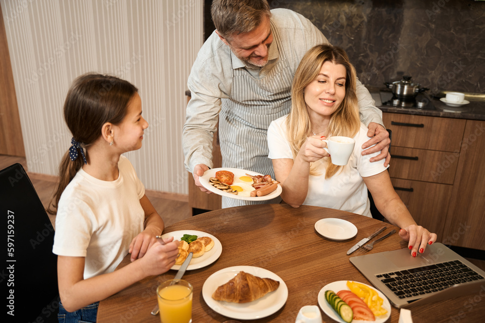 Top view happy family breakfast together in kitchen in hotel room Top view happy family breakfast together in kitchen in hotel room