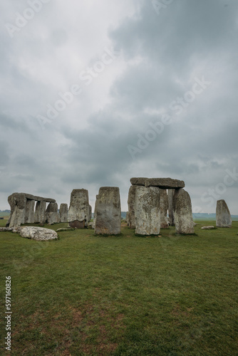 Ancient stones at UNESCO World Heritage Site at Stonehenge, Wiltshire, UK. Foggy day. Major tourist destination, archeological place