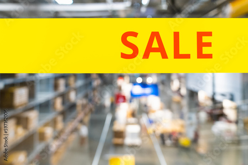 Sale text with blur product and shelf in warehouse. Black Friday shopping, electronic and furniture, Offer and Promotion on eve of Merry Christmas concepts.