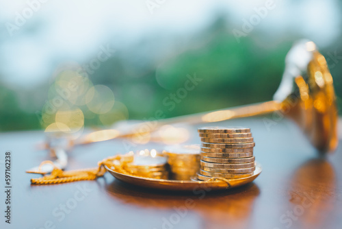 Obraz na plátně Coins stack on the scales of justice falling on the table, It represents corruption where money can overthrow the justice system