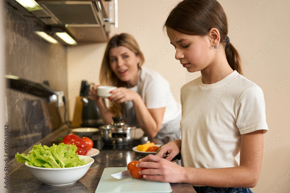 Cropped photo cute girl learning to cook breakfast for family Cropped photo cute girl learning to cook breakfast for family