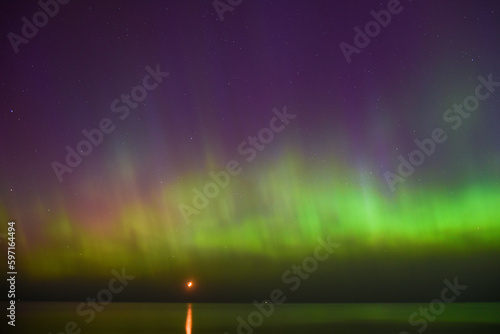 Aurora Borealis northen lights on the Baltic Sea beach in Latvia photo