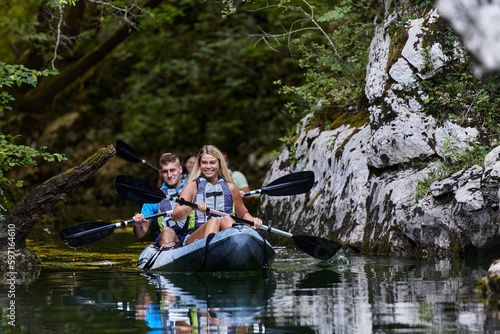 A group of friends enjoying having fun and kayaking while exploring the calm river, surrounding forest and large natural river canyons