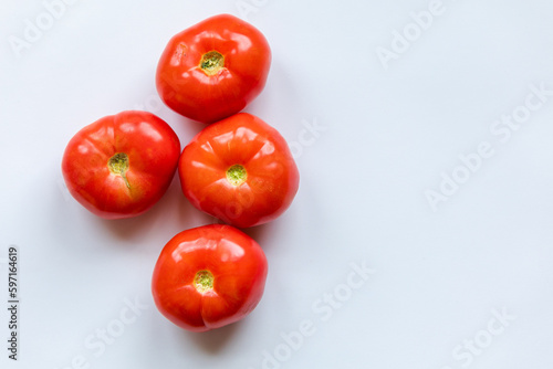 bunch of red tomatoes close up on white background © Adriana Nikolova
