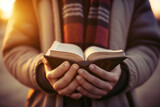 Hands Holding a Book with Soft-Focus Background 