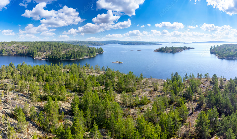 Nature of Karelia. Russia in summer. Ladoga lake. Rocky area. Coniferous taiga in Karelia. Nature of Russia. Drone view of lake Ladoga. Karelia in summer weather. Karelian islands with blue sky