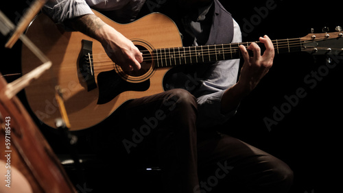 Vászonkép man playing guitar in the spotlight