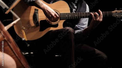 man playing guitar in the spotlight