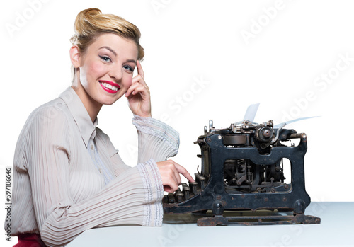Retro woman working in office with vintage typewriter and phone, dressed in pin-up style photo