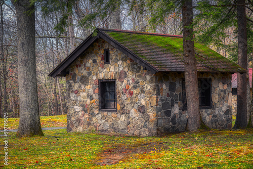 A stone building at Chenango County State Park in the Spring. Old stone building with a roof covered in moss.