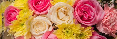 Beautiful summer banner for a website with a bouquet of bright flowers . Bouquet of pink roses, chrysanthemums and carnations.natural background for the designer.Congratulation or present concept