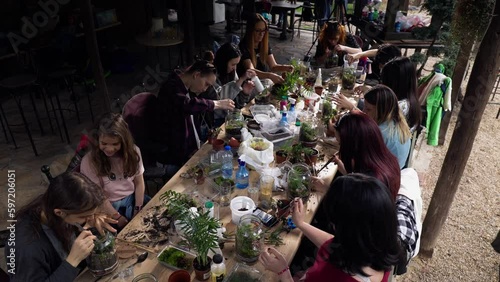 Wallpaper Mural Person making terrarium. Group of people at outdoor florarium training and seminar. Self-sustaining micro garden ecosystem. People learning to create terrariums. Zen meditation hobby. Creative meetup. Torontodigital.ca
