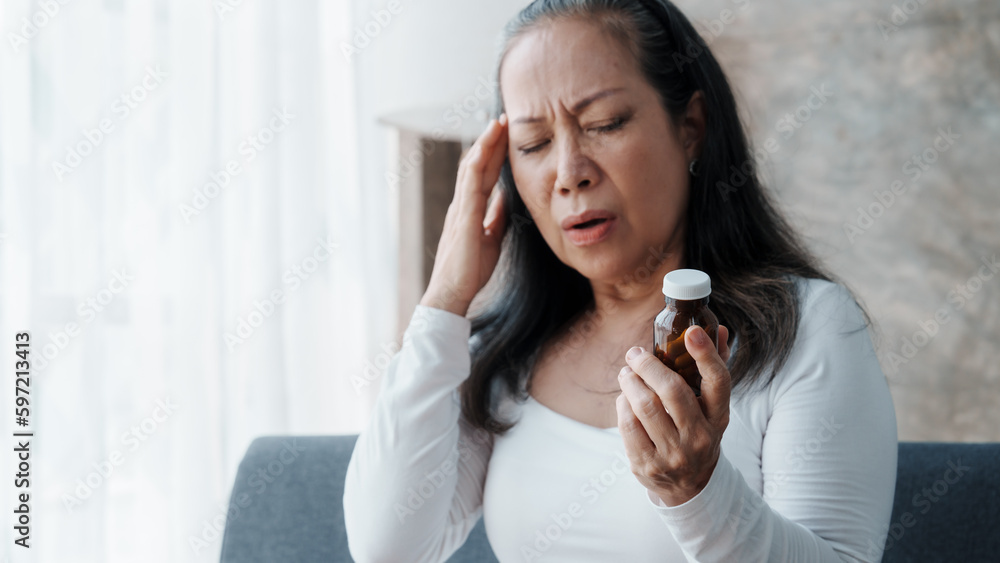 Mature woman feeling sad, asian elderly housewife anxiety depressed thinking senior chinese ethnicity.