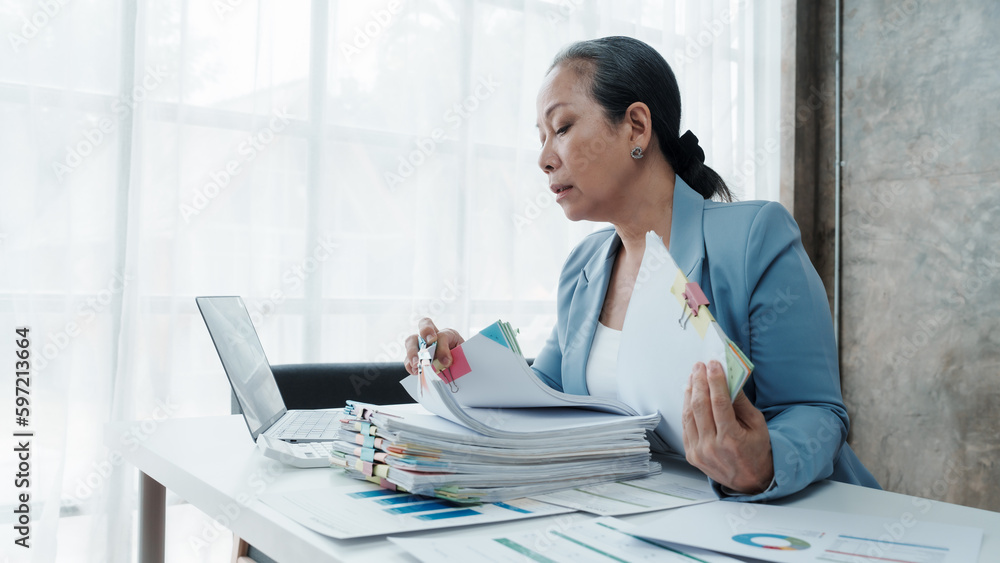 Exhausted mature asian chinese businesswoman having a headache in modern office feeling tired, overworked, crazy. Exhausted mature asian chinese businesswoman having a headache in modern office feeling tired, overworked, crazy.