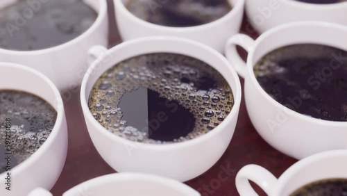 Many coffee cups on table. Cinematic.