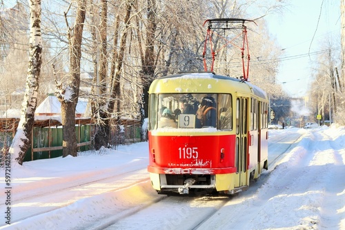 Winter sunny day, red tram