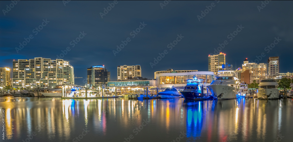 Waterfront buildings and boats at night in Sarasota Florida USA