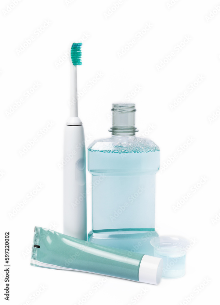 Electric toothbrush, toothpaste, mouthwash, dental floss and tongue cleaner isolated on white background. healthy teeth. Dentistry concept. Oral care. Electric toothbrush, toothpaste, mouthwash, dental floss and tongue cleaner isolated on white background. healthy teeth. Dentistry concept. Oral care.