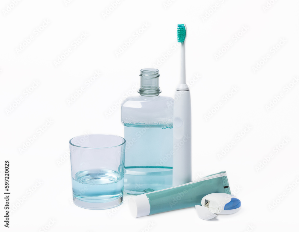 Electric toothbrush, toothpaste, mouthwash, dental floss and tongue cleaner isolated on white background. healthy teeth. Dentistry concept. Oral care. Electric toothbrush, toothpaste, mouthwash, dental floss and tongue cleaner isolated on white background. healthy teeth. Dentistry concept. Oral care.