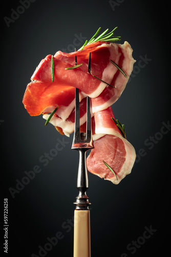 Sliced prosciutto with rosemary.