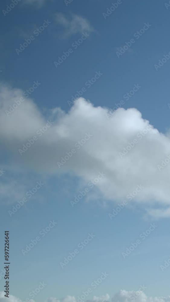 blue sky background with tiny clouds. Vertical video. blue sky background with tiny clouds. Vertical video.