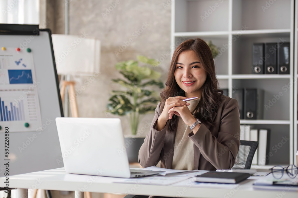 Business woman using calculator for do math finance on wooden desk in office and business working background, tax, accounting, statistics and analytic research concept.. Business woman using calculator for do math finance on wooden desk in office and business working background, tax, accounting, statistics and analytic research concept..