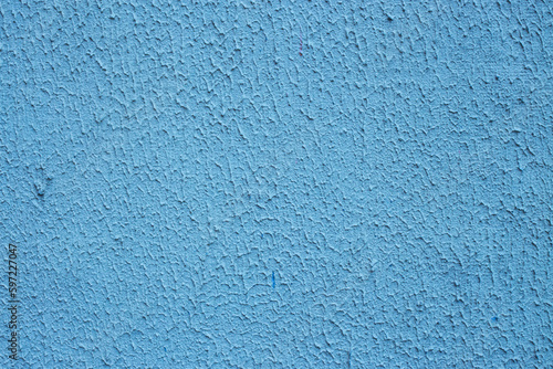 Texture of stucco painted with blue paint.
